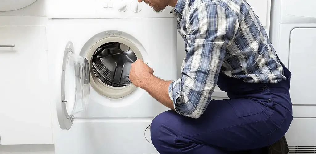Handyman inspecting a dryer drum and internal parts for repair in Honolulu, HI