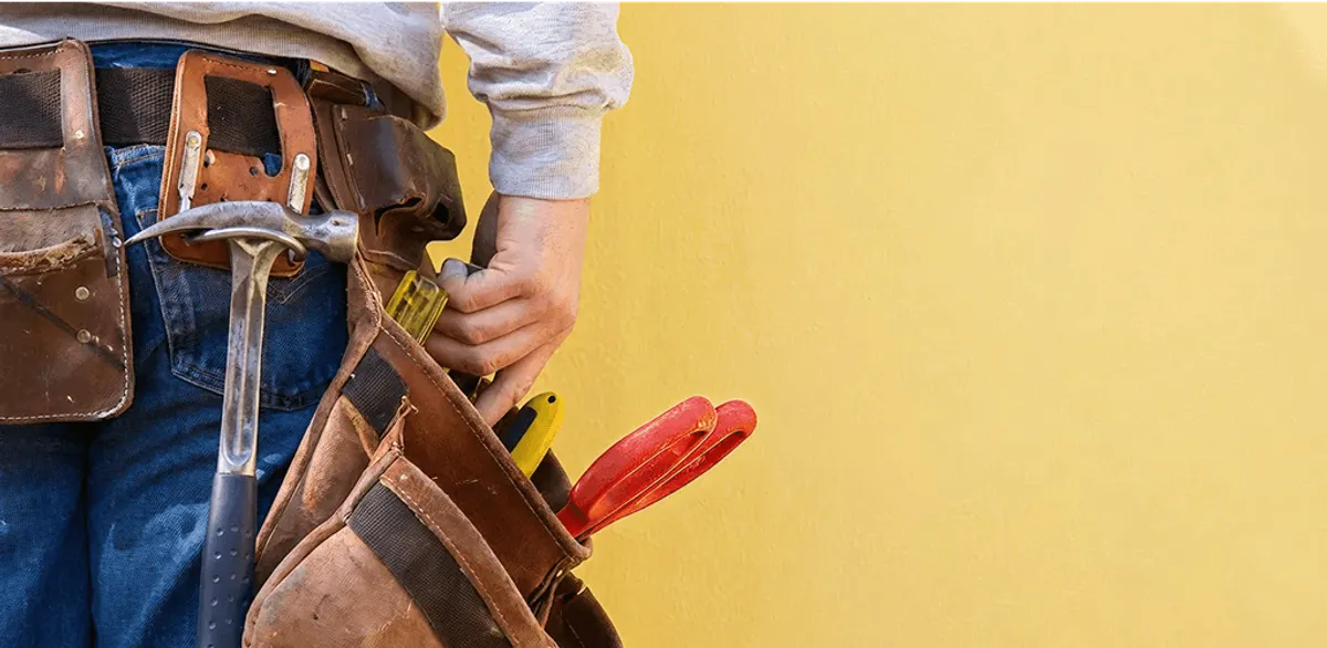Handyman with tool belt ready for home repairs and maintenance in Honolulu, HI