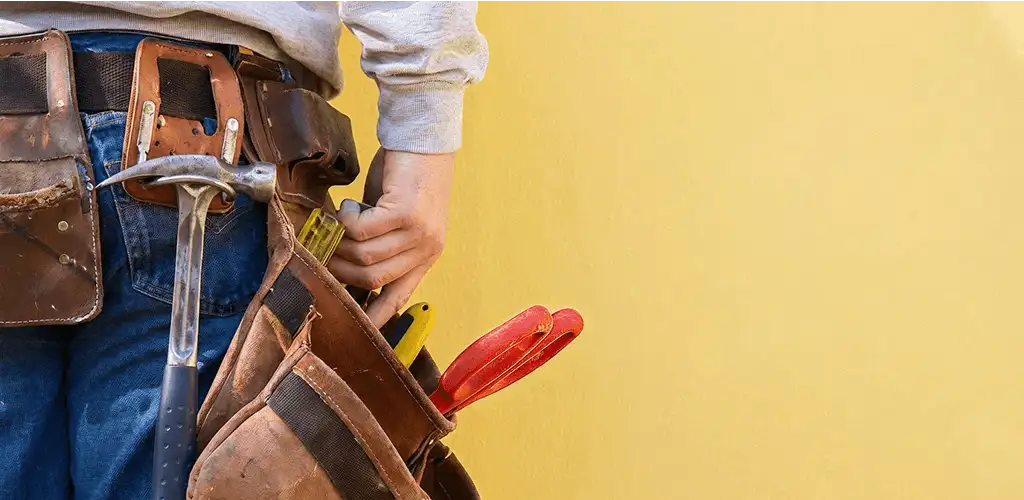 Handyman with tool belt ready for home repairs and maintenance in Honolulu, HI