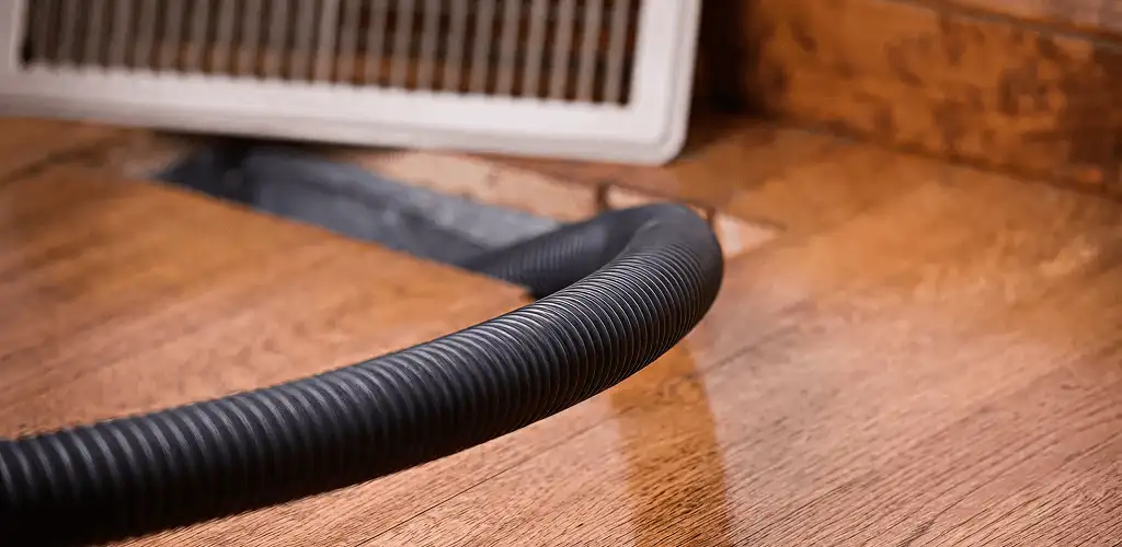 Air duct cleaning hose inserted into a floor vent for ductwork cleaning in Honolulu, HI