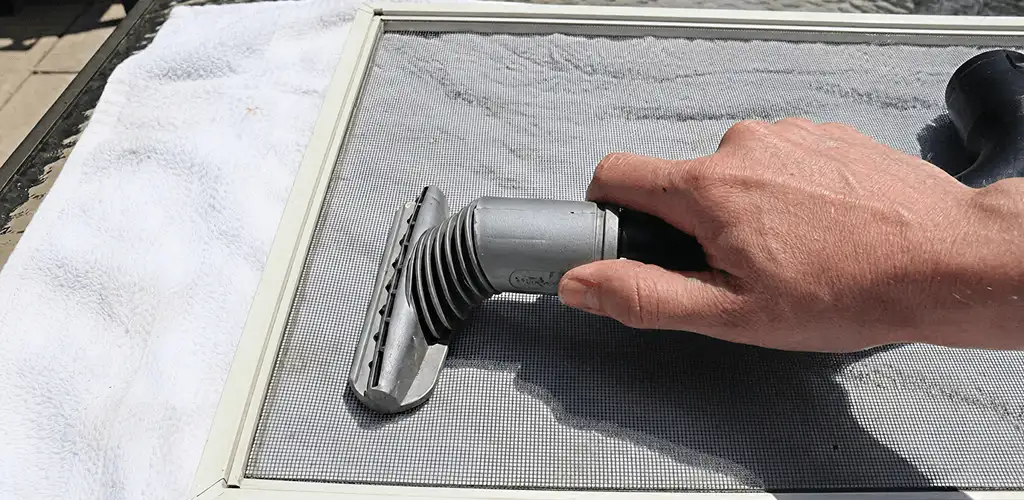 Window screen repair cleaning and fixing a damaged screen mesh in Honolulu, HI